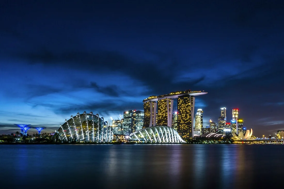 Marina Bay at dusk, the Singapore skyline lit along the water.